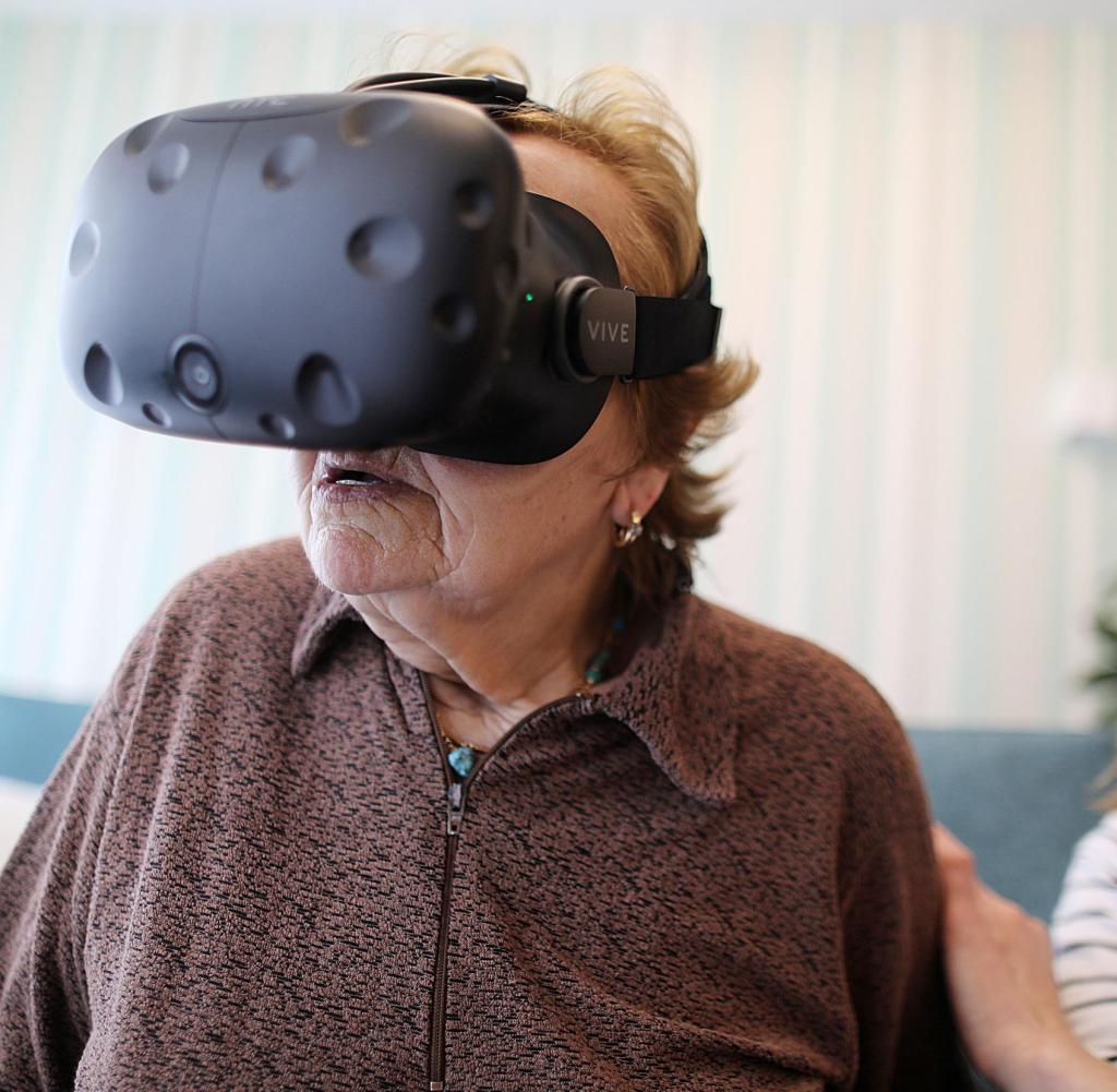 Maria Hertwig looks through Virtual Reality glasses at the Caritas-Altenzentrum St. Maternus
